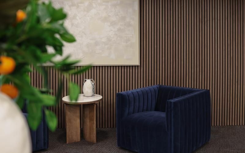 a blue chair next to a table