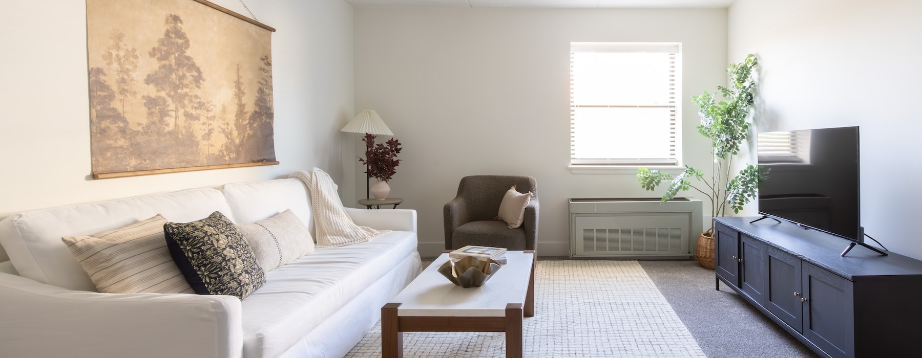 a living room with a couch, coffee table and a tv