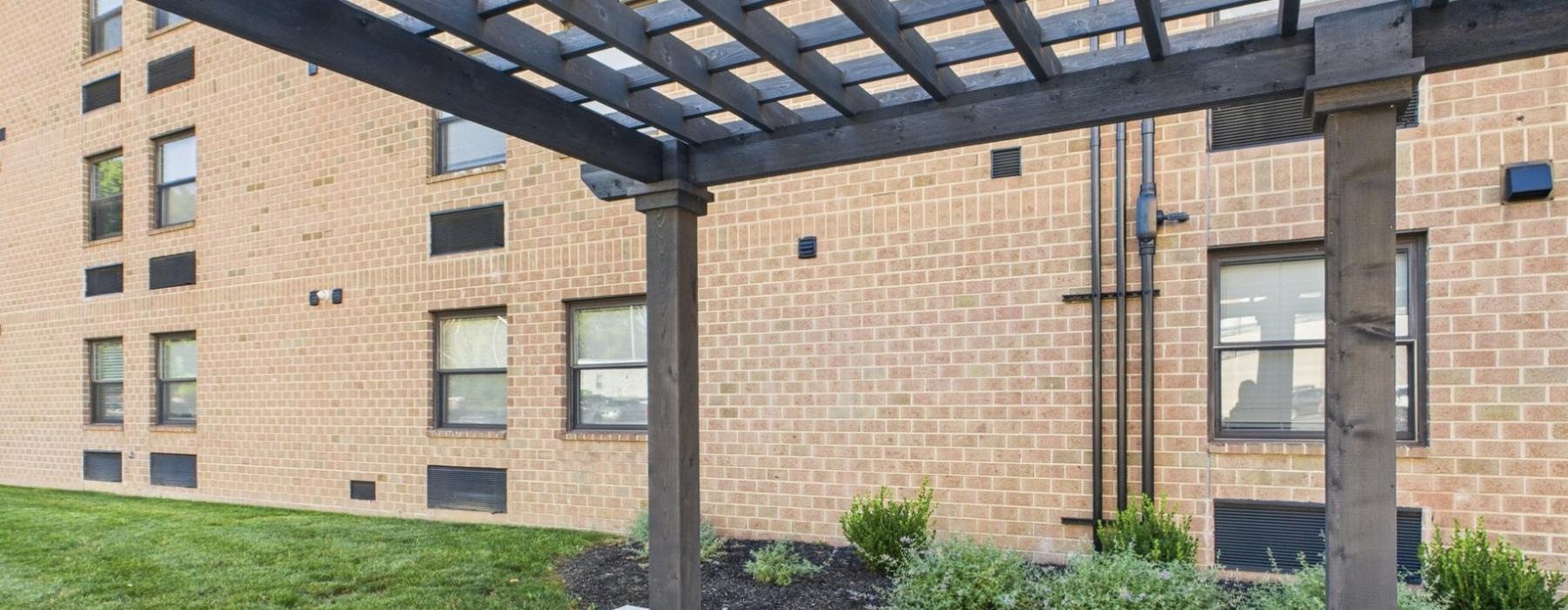 a brick building with a black awning in front