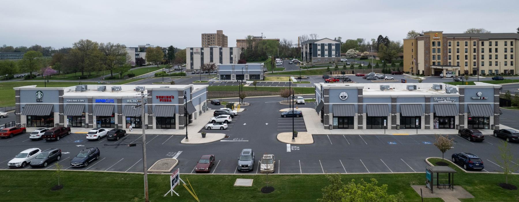 a parking lot with cars and buildings